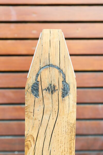 Headphones icon marked on a wooden plaque