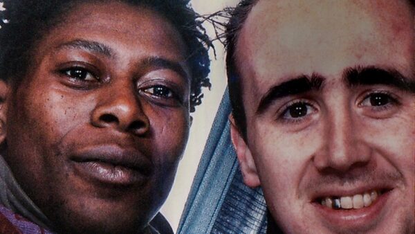 Close up image of two mens faces smiling