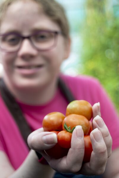 Rebecca. People harvesting food from the allotments at NEET (the Northcliffe Environmental Enterprise Team) in Northcliffe Park, where they meet several times a week. They then prepare what tehy have picked to make a lunch which they share. Photo by Tim Smith.