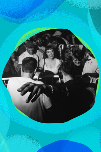 A crowd of people at a club night, in black and white.