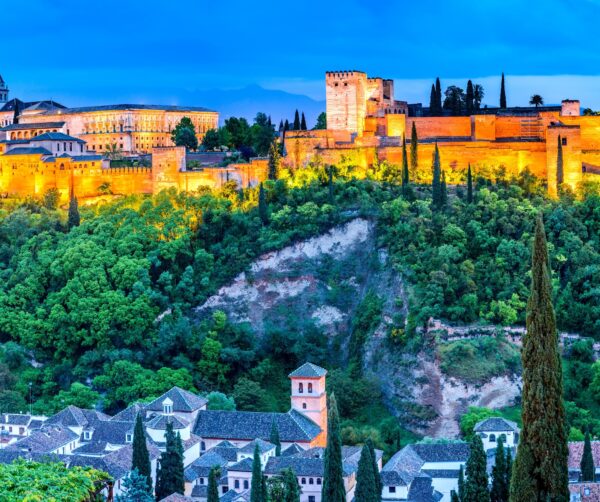 Sunset evening skyline of a fort above a village surrounded by trees
