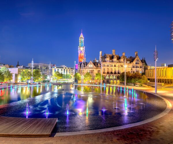 Bradford City Square's Mirror Pool and City Hall at night lit up