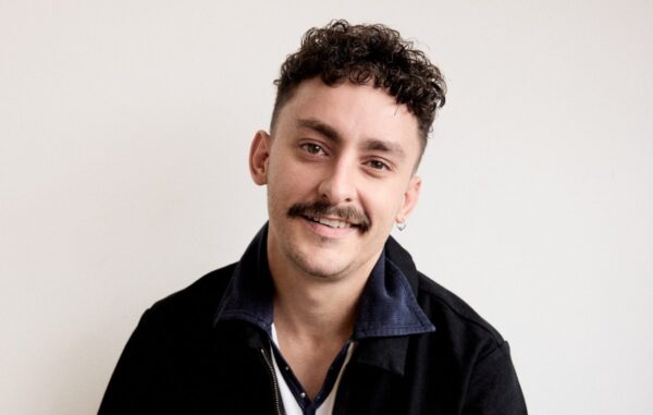 Artist Antony Szmierek smiling at the camera against a white background.