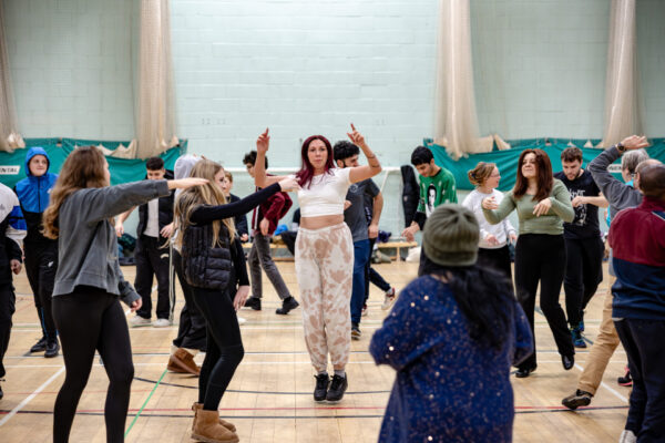 A group of performers in a dance rehearsal.