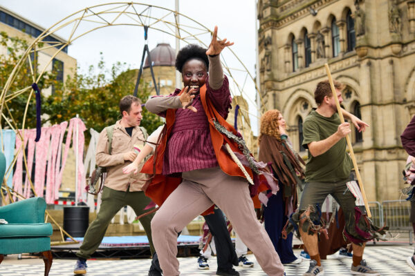 A group of performers dance in Bradford City Centre.