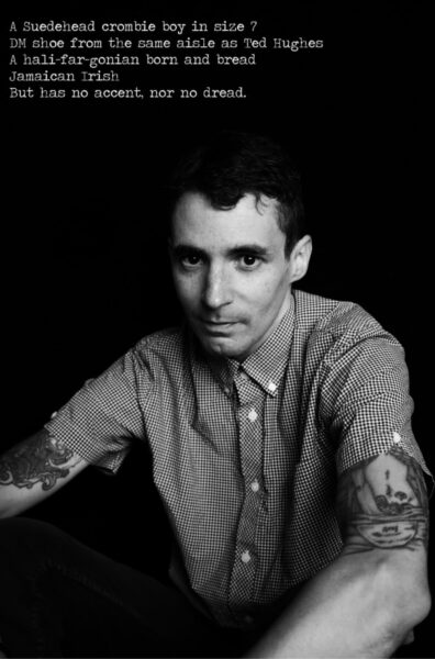 A black and white photo of a man posing for the camera.