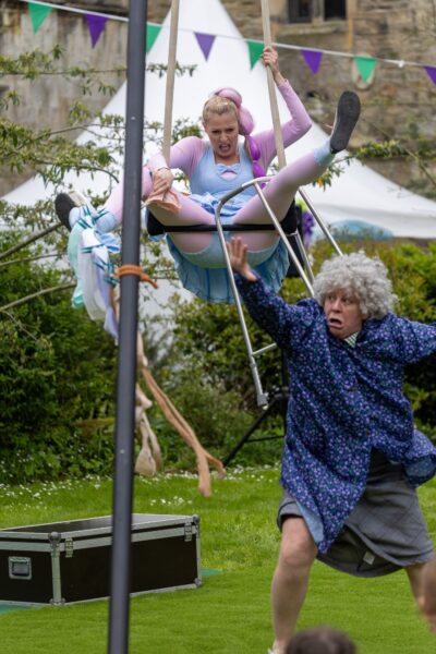 An old lady attacking a younger lady with her zimmer frame