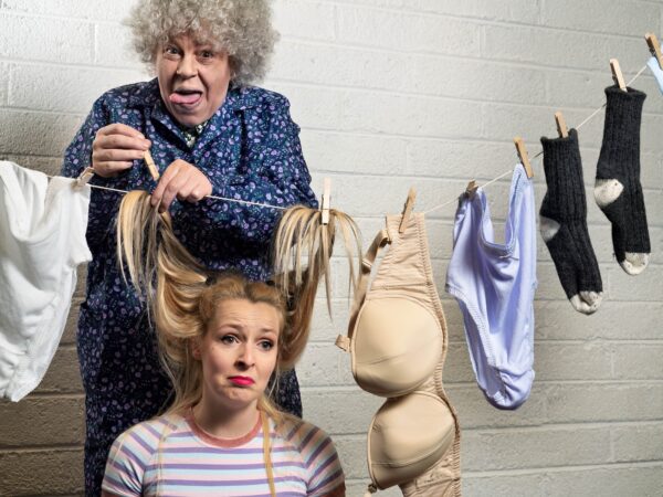 A grandma and a washing line, pegging the hair of a young lady up onto the washing line