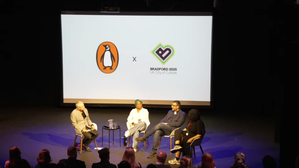 Three panellists on a stage, in front of the Bradford 2025 logo and Penguin Books logo.