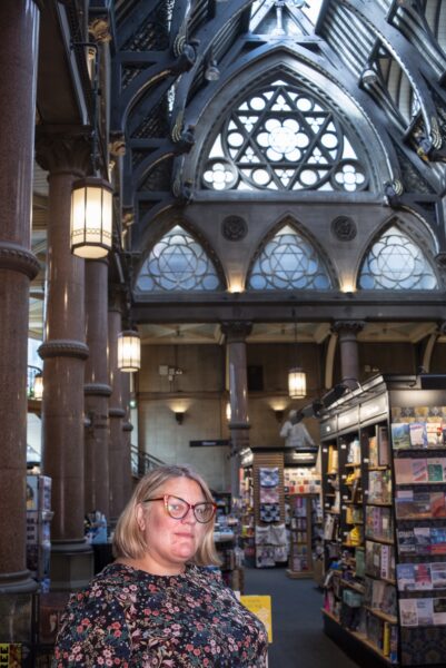 Abigail Guessis, Manager of the bookshop at The Wool Exchange in central Bradford. This Grade 1 listed building was built as a wool-trading centre in the late 19th century, and the grandeur of its architecture is symbolic of the wealth and importance that wool brought to Bradford. Today the main body of the building is a Waterstones bookshop and cafe. Photo by Tim Smith.