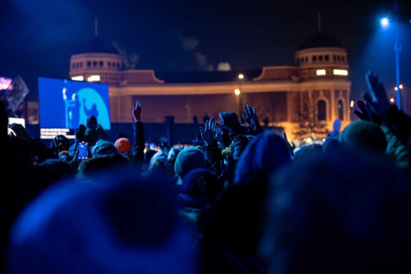 A crowd of people stand in front of Bradford Live during a performance of RISE.