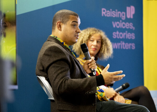 A man talks into a microphone.