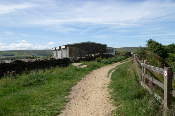 country path with a building on the left