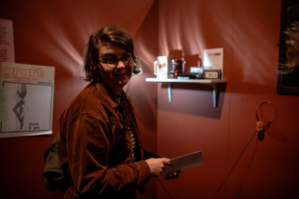 A person poses in the exhibition.