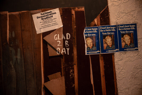 A wall decorated with historical posters and signage.
