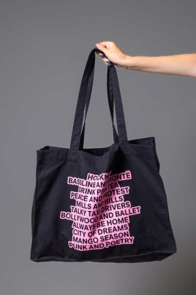 A black Bradford 2025 tote bag with pink writing on it.