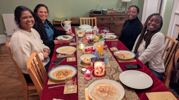 Four people sat around a dining table