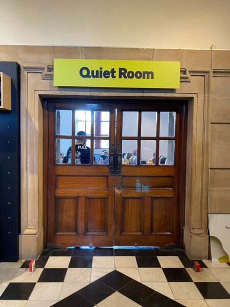 A brown door with a sign above it reading Quiet Room.