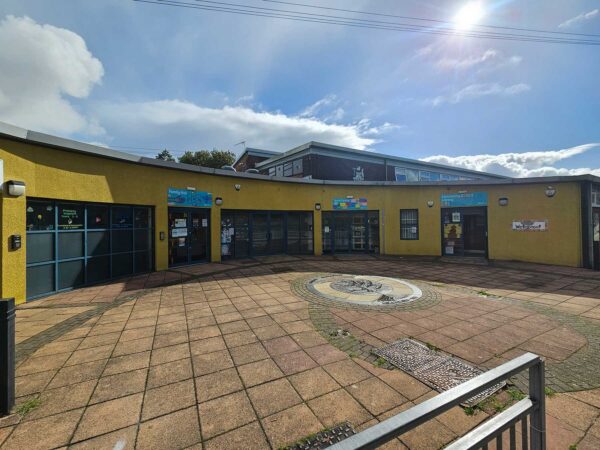 An exterior image of the TFD Centre. It is a single storey yellow building.