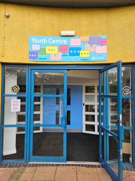 The TFD Centre entrance, with blue doors and a sign that reads 'Youth Centre'