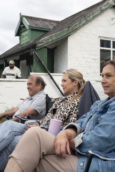 People sat outside watching the cricket Denholme vs Haworth 1st teams playing each other at Denholme Cricket Club in the Second Division of the Craven & District Cricket League, a league in which many of the Bradford District teams play. Photos by Tim Smith.