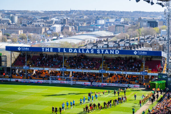 Football stadium, focused on one of the stands labelled TL Dallas.