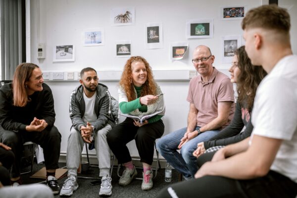 Kirsty Taylor sat in a circle chatting with a group of adults