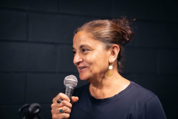 Sudhar Bulchar speaking into a microphone