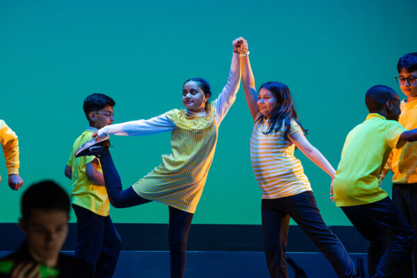 Young children dancing ballet on stage