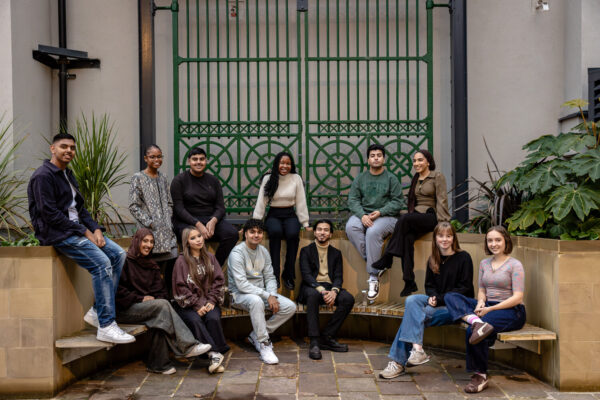 Young people posing outsise infront of gates