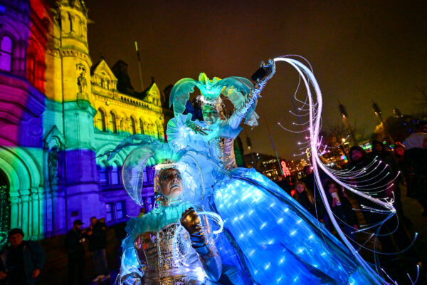 Two ladies dressed up in a ballgownsa nd led lights and light up accessories