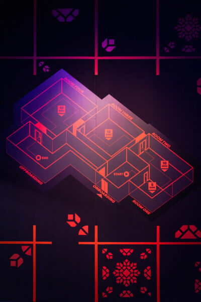 Glowing orange drawings on walls in room one of Built by Sound in the basement of Loading Bay.