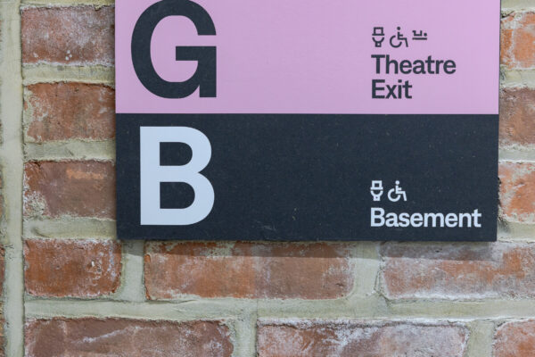 Sign near the lift in Loading Bay, with ground and basement information.