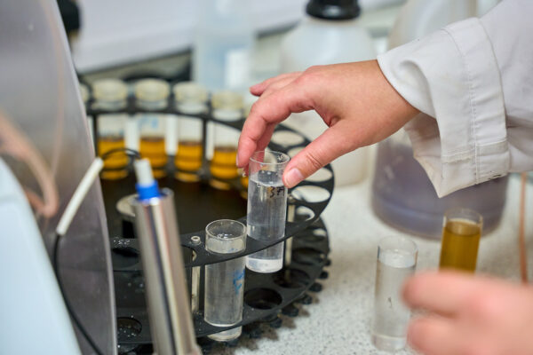 A test tube is put into a rotary mixer in a laboratory.